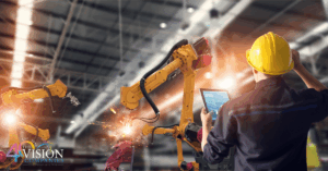 Industrial worker using a digital tablet to operate robotic arms in a modern manufacturing facility, symbolizing innovation and technology in manufacturing.