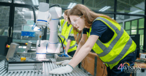 Female manufacturing worker operating robotic equipment in a modern factory, representing women’s growing role in advanced manufacturing